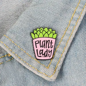 Detail of Plant Lady enamel pin with succulent design on light blue denim jacket lapel