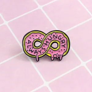 Macro detail of pink donut infinity pin with Always Hungry text engraving