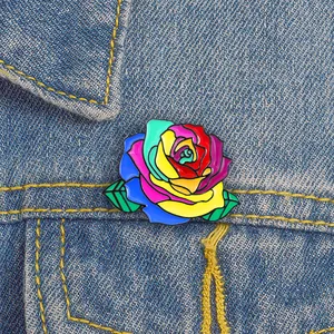 Colorful cartoon rose enamel brooch pinned on a blue denim jacket pocket detail