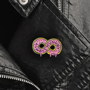 Pink donut infinity symbol enamel pin with Always Hungry text on a black leather jacket