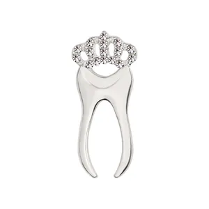 Close-up of crown tooth brooch with silver metal base and sparkling rhinestones