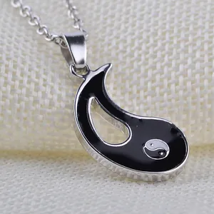Macro detail of silver Yin Yang pendant necklace with black enamel inlay work