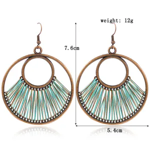 Bohemian geometric round drop earrings with teal thread weave and bronze metal finish