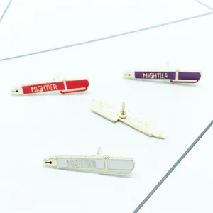 Creative enamel fountain pen brooches with Mightier text in red, purple, and white colors