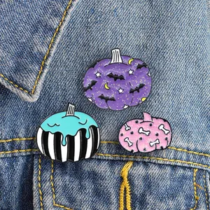 Three-piece Halloween pumpkin enamel pins with bat and bone patterns on denim jacket