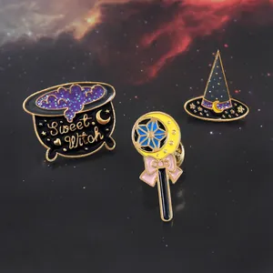 Macro detail of Halloween enamel brooch set featuring sweet witch hat and magic wand