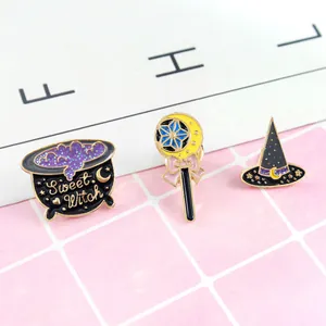 Detailed close-up of sweet witch enamel pins featuring magic hat, cauldron, and moon wand