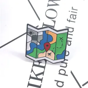 Macro shot of colorful enamel travel map brooch with airplane and location pins