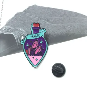 Enamel brooch pin featuring a purple magic potion bottle with gems and MAGIC ribbon banner