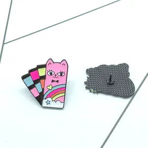 Colorful cartoon cat enamel brooch with rainbow and star motifs on white background