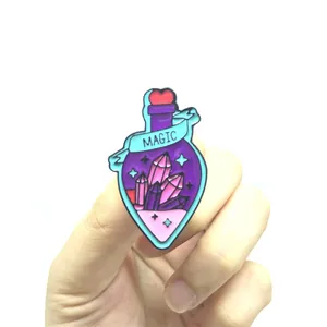 Detailed close-up of a purple magic potion bottle enamel pin with heart and MAGIC ribbon