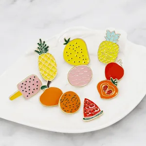 Cute fruit enamel brooch set featuring pineapple and strawberry on a white ceramic plate