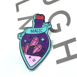 Detail of a purple magic potion enamel pin with pink crystals and a red heart cap