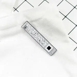 Macro detail of creative Photoshop toolbar enamel brooch pinned on a white canvas bag