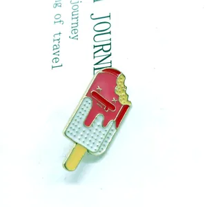 Macro view of strawberry ice cream enamel pin with metallic glitter and bitten shape