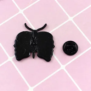 Black enamel skull butterfly brooch back view showing the pin and secure clutch