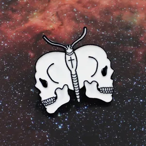 Gothic butterfly skull brooch with white enamel finish on a starry background