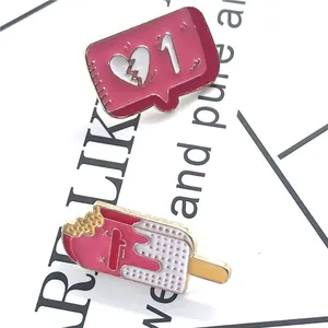 Two-piece set of enamel pins with broken heart social icon and bitten ice cream bar