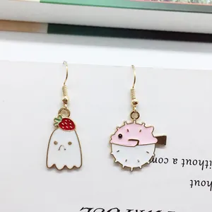 Asymmetric Halloween gold earrings with a white ghost strawberry and pink puffer fish