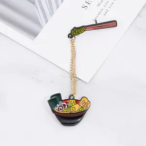 Detailed macro view of a Japanese ramen bowl enamel pin with golden connecting chains