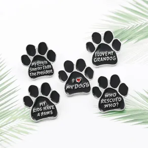 Macro detail of dog paw enamel pins featuring pet slogans on a white background