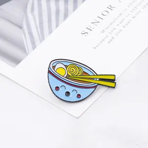 Close-up of cute blue ramen noodle bowl enamel pin on a minimalist card background