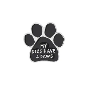 Detailed close-up of enamel dog paw badge with My Kids Have 4 Paws inscription