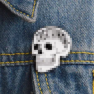 8-bit pixel art skull enamel pin badge on blue denim jacket pocket accessory