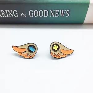 Cute orange wing enamel pin set with blue arrow and yellow cross for denim jackets