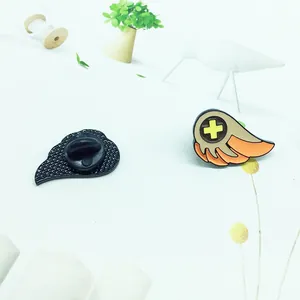 Detail of cartoon angel wing enamel pins with rubber backs for jackets and bags