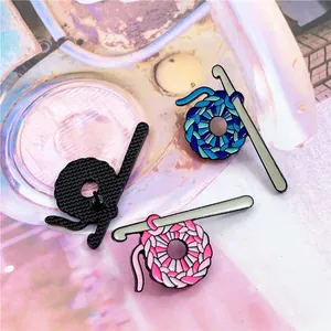 Detailed macro view of colorful woven ball enamel brooches and secure back pin closure