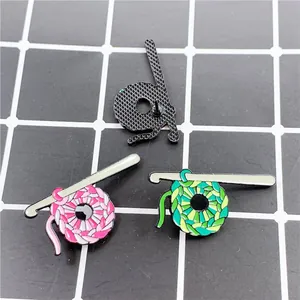 Handmade crochet and yarn ball enamel pins in pink and green for bags and clothes