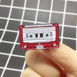 Detail of a retro red cassette tape enamel pin featuring 60 MIN and A side engraving