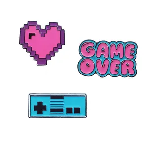 Three-piece retro gaming enamel pins set featuring Game Over text and vintage controller