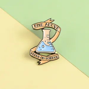 Cute chemistry beaker enamel pin with blue liquid and Focus on Science text