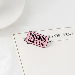 Pink Friends Don't Lie speech bubble enamel pin accessory for jackets and bags