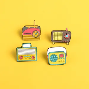 Vue à plat de quatre broches radio vintage en émail sur fond jaune vif