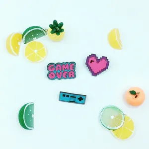 Macro detail of Game Over controller pendant with pixel heart and fruit charms