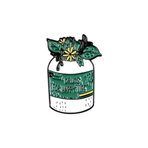 Detail of enamel pin featuring a white jar with green plants and Happy Life text