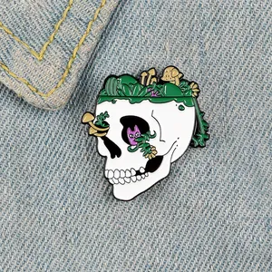 Cartoon skull enamel pin with mushrooms and flowers on denim background