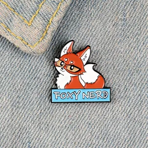 Close-up of Foxy Nerd enamel pin with cartoon fox on blue denim jacket fabric