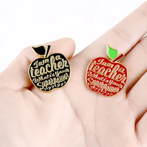 Apple enamel brooches for teachers in red and black with golden superpower text