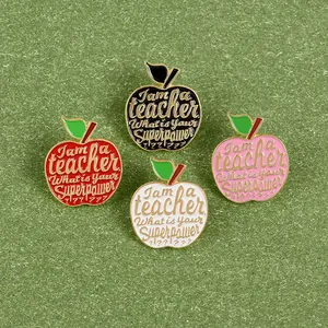 Macro shot of four colorful apple enamel pins for teacher appreciation gifts