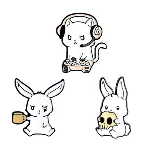 Three-piece set of cartoon enamel pins featuring gaming cat and grumpy white rabbits