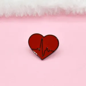 Red enamel heart brooch with black heartbeat ECG line and sleek metallic trim details