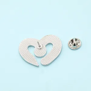 Detailed back view of a heart-shaped silver enamel pin with textured metal and butterfly clutch