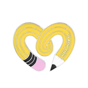 Creative heart-shaped enamel pin featuring a yellow pencil with Make More Art text