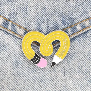 Creative heart shaped yellow pencil enamel pin with Make More Art quote on denim jacket