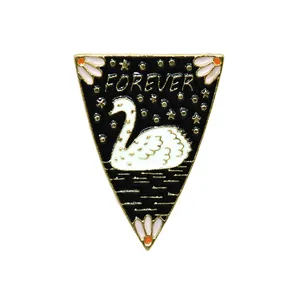Cartoon white swan enamel brooch with Forever text and stars on a black triangle base