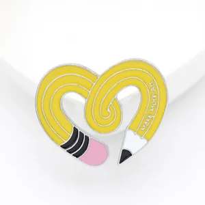 Creative heart-shaped yellow pencil enamel pin featuring Make More Art text